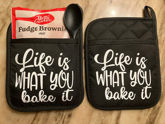 Life is What you Bake it Gift Set, with Message in White on 2 Black Pot Holders, 1 Dessert Mix, 1 Spatula or Spoon.